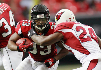 ATLANTA - SEPTEMBER 19:  Michael Turner #33 of the Atlanta Falcons rushes against Adrian Wilson #24 of the Arizona Cardinals at Georgia Dome on September 19, 2010 in Atlanta, Georgia.  (Photo by Kevin C. Cox/Getty Images)