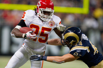 ST. LOUIS, MO - DECEMBER 19: Jamaal Charles #25 of the Kansas City Chiefs looks to get by Craig Dahl #43 of the St. Louis Rams at the Edward Jones Dome on December 19, 2010 in St. Louis, Missouri.  The Chiefs beat the Rams 27-13.  (Photo by Dilip Vishwana