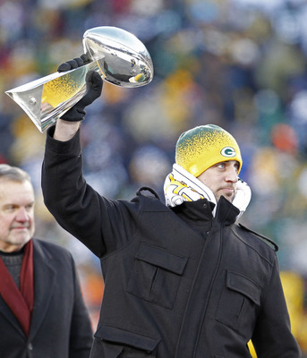 GREEN BAY, WI - FEBRUARY 08:  Green Bay Packers quarterback Aaron Rodgers hoists the Lombardi Trophy during the Packers victory ceremony at Lambeau Field on February 8, 2011 in Green Bay, Wisconsin.  (Photo by Matt Ludtke/Getty Images)