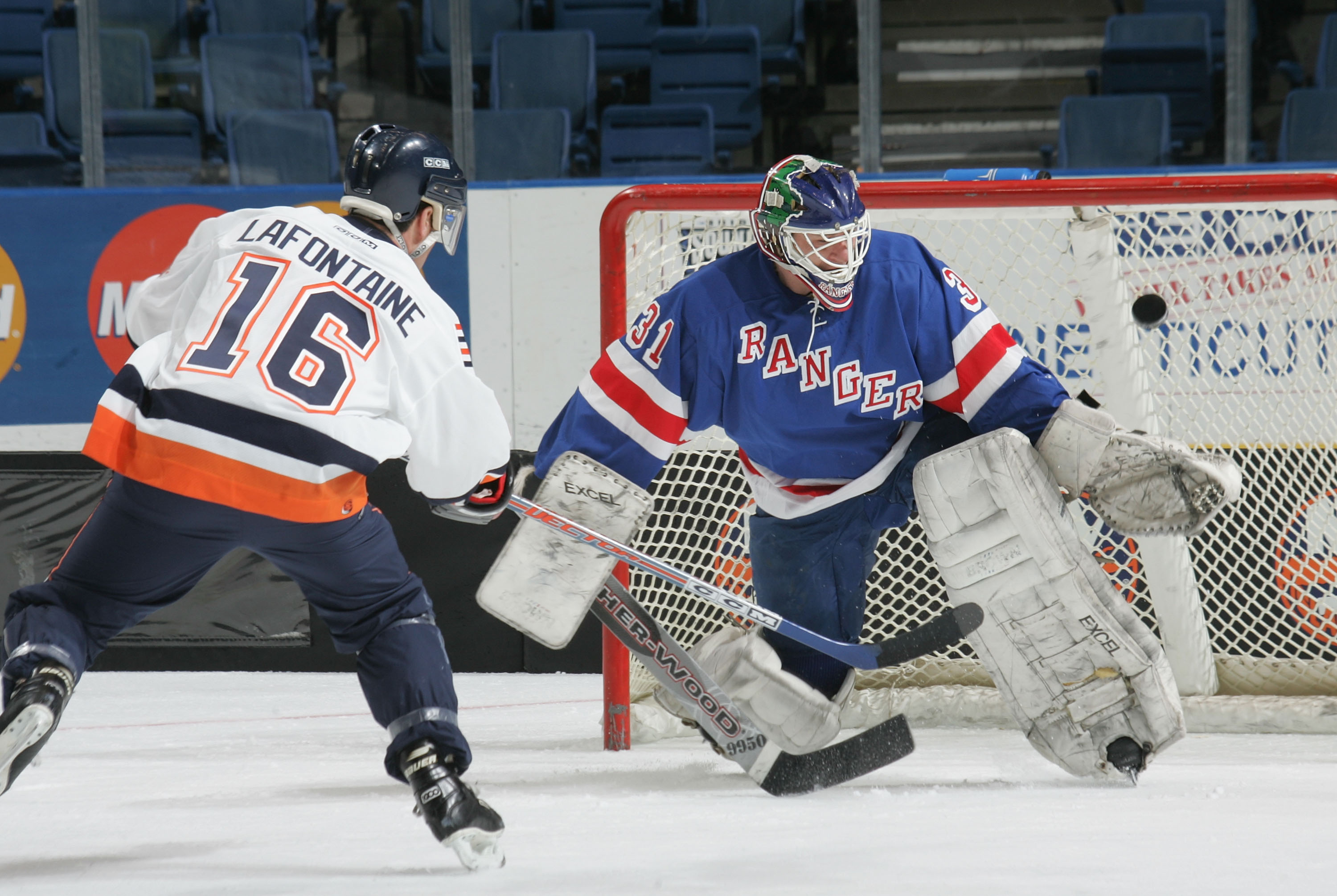 UNIONDALE, NY - APRIL 16:  Pat Lafontaine #16 of the New York Islanders Alumni scores on Mark Laforest #31 of the New York Ranger Alumni team during the Hockey for Heroes 3 on 3 Hockey Tournament on April 16, 2005 at Nassau Coliseum in Uniondale, New York