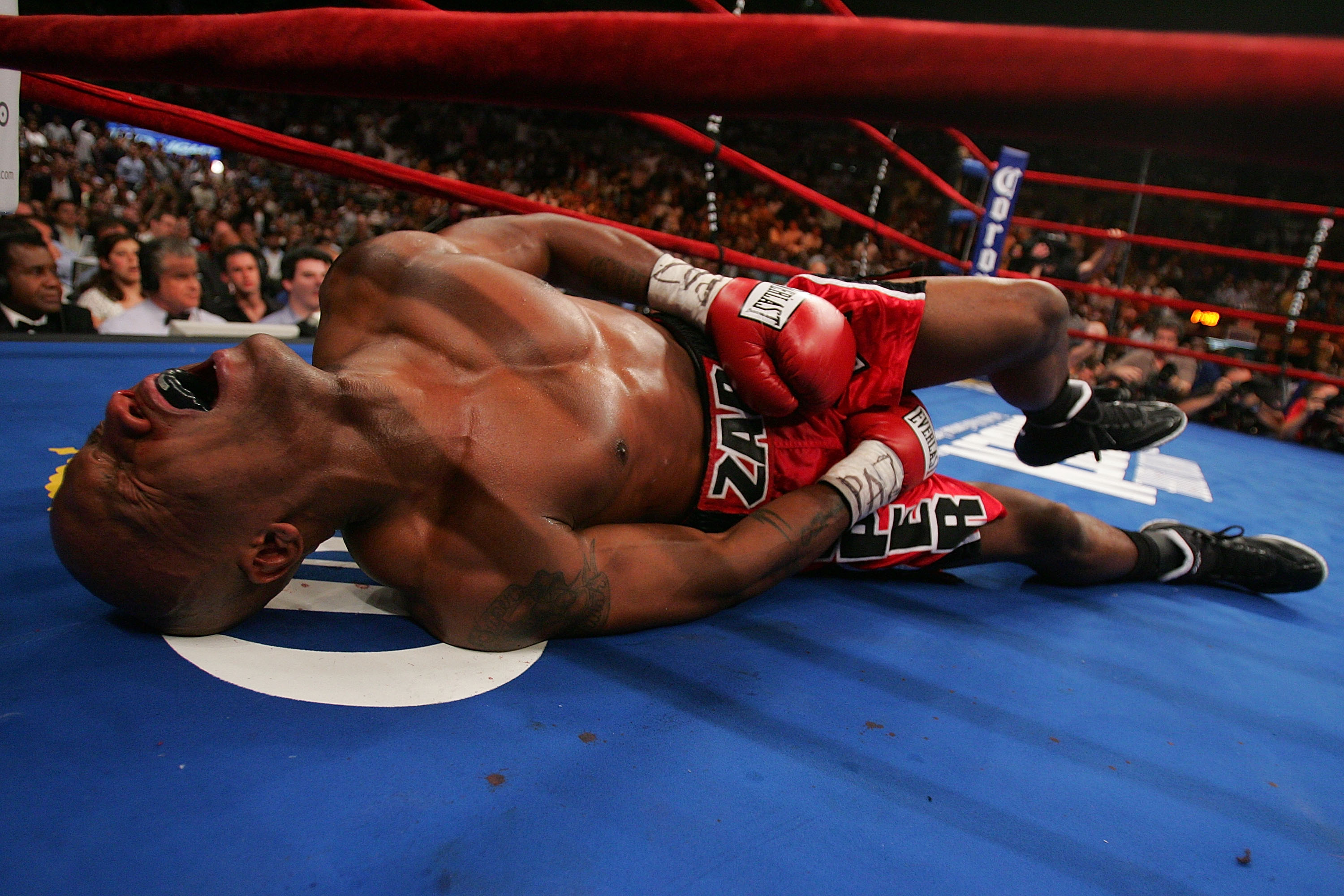 NEW YORK - JUNE 9: Zab Judah lays in agony on the canvas after being hit by a second low blow by Miguel Cotto of Puerto Rico during their WBA Welterweight Championship bout on June 9, 2007 at Madison Square Garden in New York City. (Photo by Nick Laham/Ge