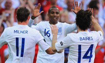 LONDON, ENGLAND - JUNE 04:  Ashley Young of England (C) celebrates scoring their second goal with teammates James Milner (L) and Leighton Baines during the UEFA EURO 2012 group G qualifying match between England and Switzerland at Wembley Stadium on June