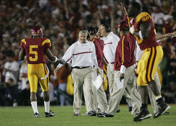 PASADENA, CA - JANUARY 04: Head coach Pete Carroll of the USC Trojans congratulates running back Reggie Bush #5 after teammate LenDale White #21 scored on a 4-yard run against the Texas Longhorns in the first quarter during the BCS National Championship