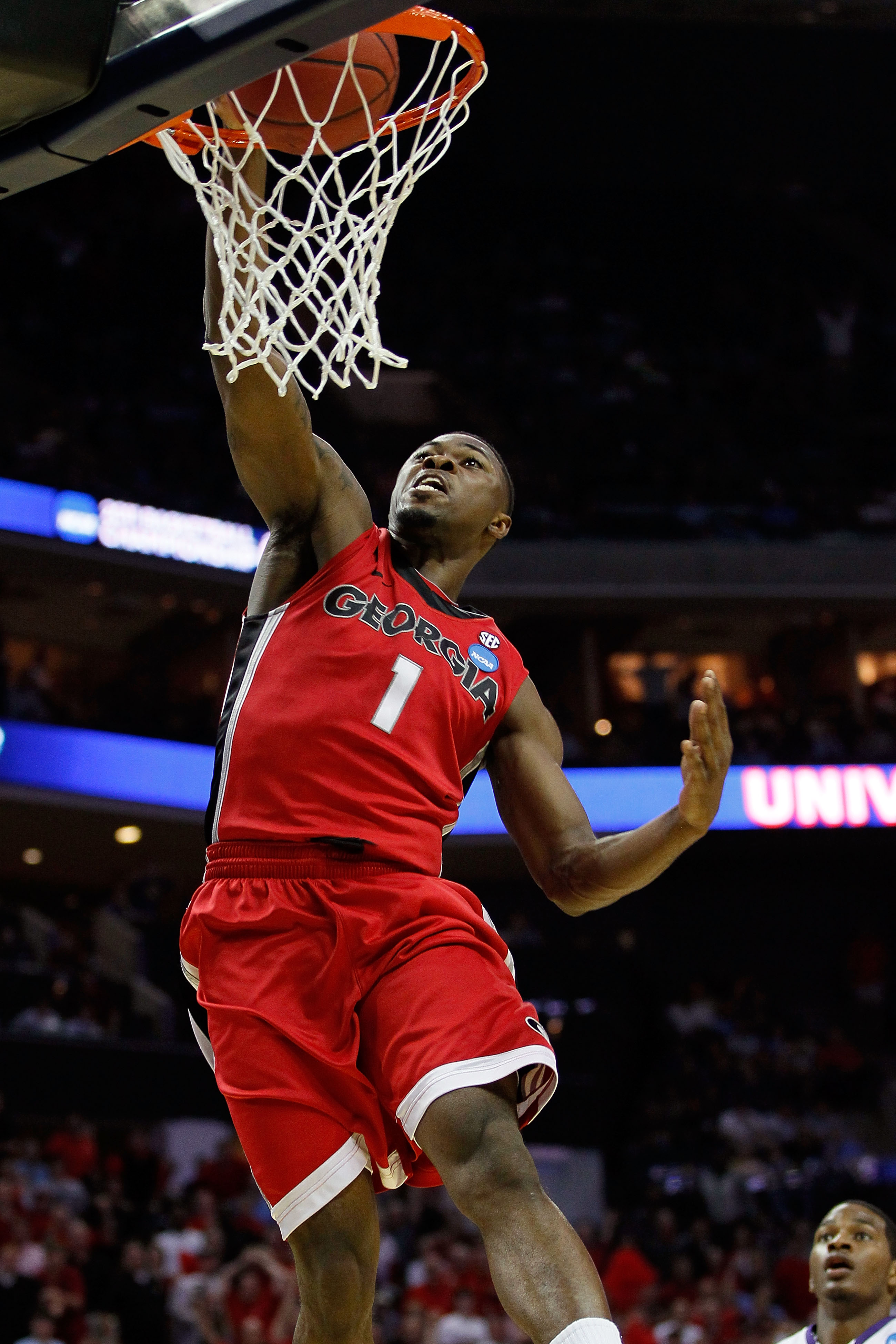 CHARLOTTE, NC - MARCH 18:  Travis Leslie #1 of the Georgia Bulldogs dunks the ball in the first half while taking on the Washington Huskies during the second round of the 2011 NCAA men's basketball tournament at Time Warner Cable Arena on March 18, 2011 i