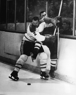 Canadian professional hockey player Doug Harvey of the Montreal Canadiens slams an opponent against the boards to keep him away from the puck, 1950s. (Photo by Pictorial Parade/Getty Images)