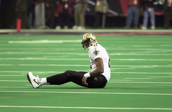 ATLANTA - NOVEMBER 17:  Aaron Brooks #2 of the New Orleans Saints sits on the turf after a play during the NFL game against the Atlanta Falcons at the Georgia Dome on November 17, 2002 in Atlanta, Georgia. The Falcons defeated the Saints 24-17. (Photo by 