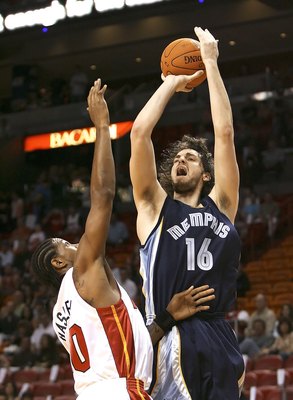 MIAMI - DECEMBER 16:  Pau Gasol #16 of the Memphis Grizzlies shoots over Udonis Haslem #40 of the Miami Heat at American Airlines Arena on December 16, 2006 in Miami, Florida. NOTE TO USER: User expressly acknowledges and agrees that, by downloading and o