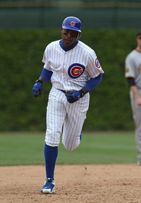 CHICAGO, IL - MAY 12: Carlos Pena #22 of the Chicago Cubs stands at first  base as a detail view of the back of his jersey can be seen against the St.