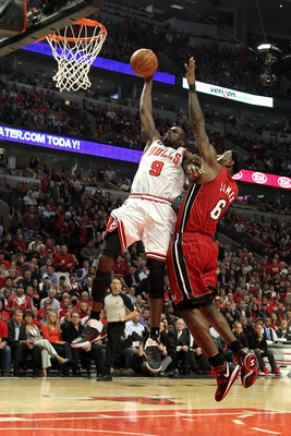 CHICAGO, IL - MAY 26:  Luol Deng #9 of the Chicago Bulls dunks against LeBron James #6 of the Miami Heat in Game Five of the Eastern Conference Finals during the 2011 NBA Playoffs on May 26, 2011 at the United Center in Chicago, Illinois. NOTE TO USER: Us