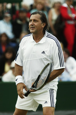 LONDON - JULY 1:  Ilie Nastase of Romania in action during the Gentlemen's over 45 Doubles match at the Wimbledon Lawn Tennis Championships held on July 1, 2003 at the All England Lawn Tennis and Croquet Club, in Wimbledon, London. (Photo by Alex Livesey/