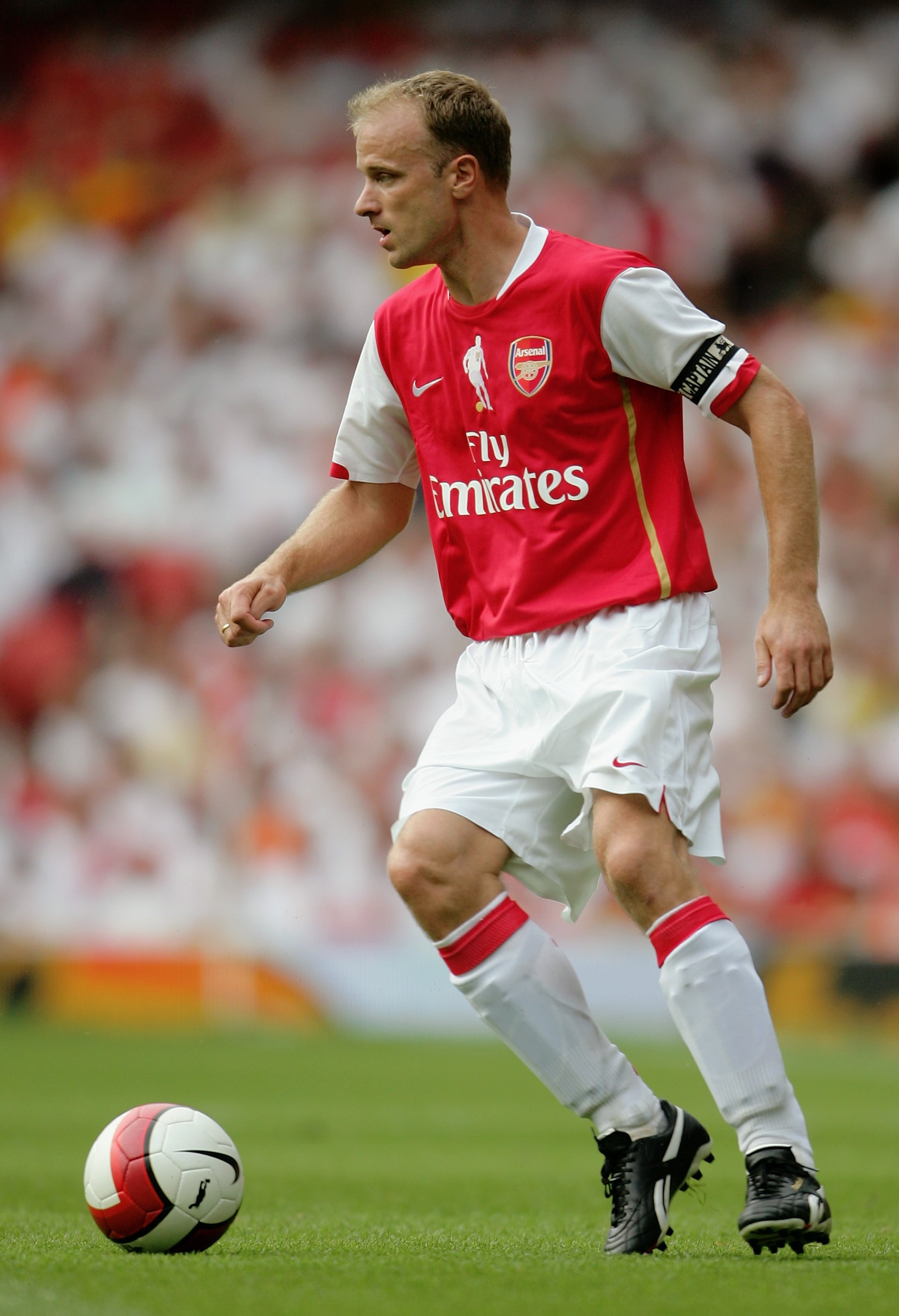 LONDON - JULY 22:  Dennis Bergkamp of Arsenal runs with the ball during the Dennis Bergkamp testimonial match between Arsenal and Ajax at the Emirates Stadium on July 22, 2006 in London, England.  (Photo by Jamie McDonald/Getty Images)