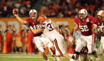 MIAMI, FL - JANUARY 03:  Andrew Luck #12 of the Stanford Cardinal throws a pass under pressure from Chris Drager #33 of the Virginia Tech Hokies during the 2011 Discover Orange Bowl at Sun Life Stadium on January 3, 2011 in Miami, Florida. Stanford won 40