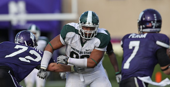 EVANSTON, IL - OCTOBER 23: Jerel Worthy #99 of the Michigan State Spartans moves past a block attempt by Brian Mulroe #72 of the Northwestern Wildcats with his sights set on Dan Persa #7 at Ryan Field on October 23, 2010 in Evanston, Illinois. Michigan St