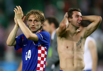 VIENNA, AUSTRIA - JUNE 20:  Darijo Srna of Croatia holds his head as Luka Modric acknowledges the fans after defeat in the UEFA EURO 2008 Quarter Final match between Croatia and Turkey at Ernst Happel Stadion on June 20, 2008 in Vienna, Austria.  (Photo b