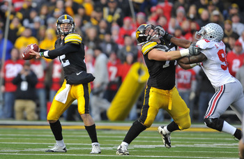 IOWA CITY, IA - NOVEMBER 20:  Quarterback Ricky Stanzi #12 of the University of Iowa Hawkeyes throws under pressure from defensive lineman Solomon Thomas #98 of the Ohio State Buckeyes as offensive lineman Riley Reiff #77 defends during the first half of 