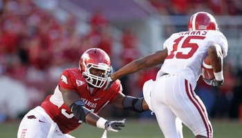 FAYETTEVILLE - SEPTEMBER 25: Darius Hanks #15 of the Alabama Crimson Tide tries to get around a tackle attempt by Jerry Franklin #34 of the Arkansas Razorbacks at Donald W. Reynolds Razorback Stadium on September 25, 2010 in Fayetteville, Arkansas. Alabam