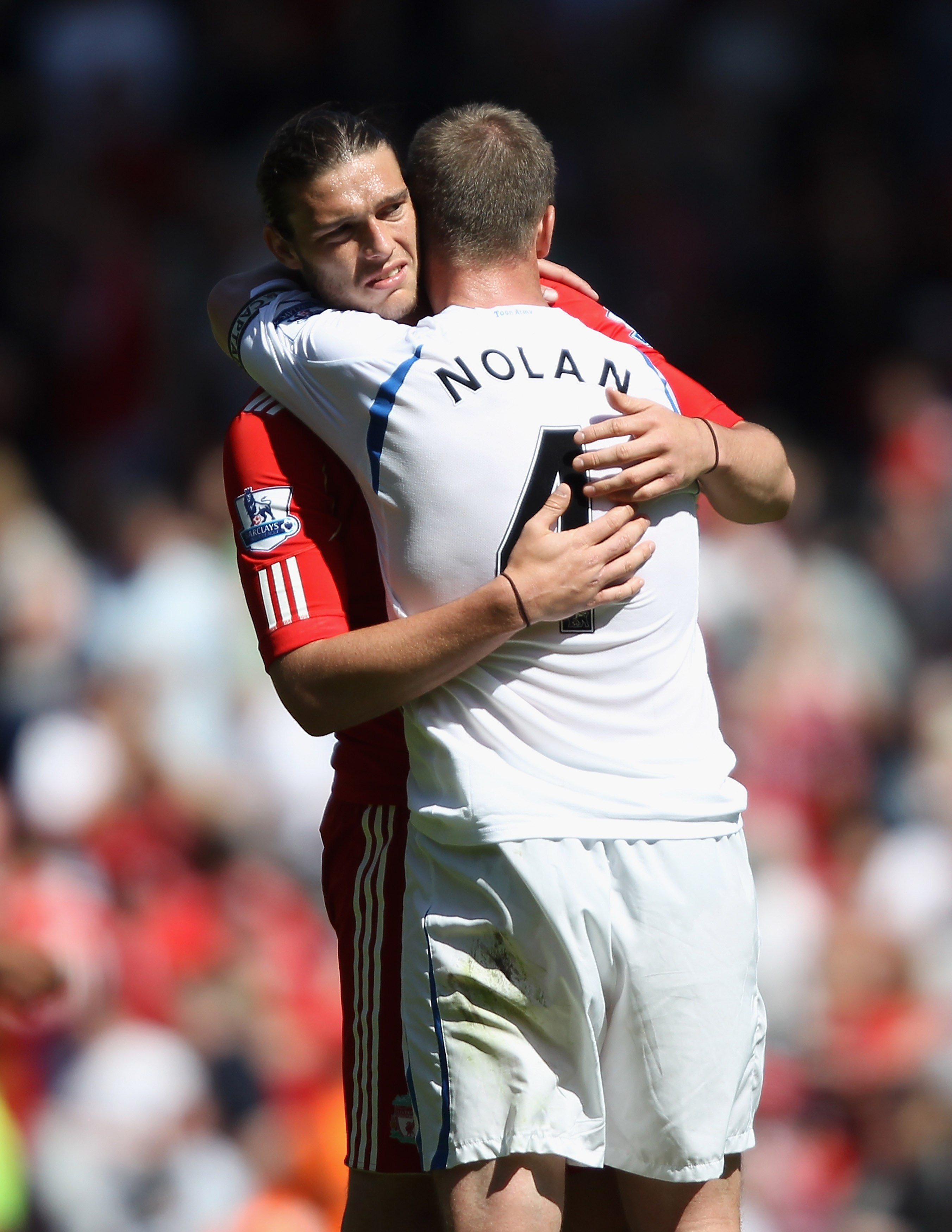 LIVERPOOL, ENGLAND - MAY 01:  Andy Carroll of Liverpool hugs Kevin Nolan of Newcastle United at the final whistle of the Barclays Premier League match between Liverpool  and Newcastle United at Anfield on May 1, 2011 in Liverpool, England.  (Photo by Cliv