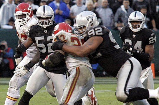 Mike Haynes #22 of the Los Angeles Raiders looks on from the bench against  the Kansas City…