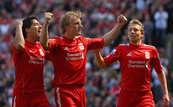 LIVERPOOL, ENGLAND - MAY 01:  Dirk Kuyt of Liverpool celebrates with team mates Luis Suarez and  Lucas after scoring the second goal from the penalty spot during the Barclays Premier League match between Liverpool  and Newcastle United at Anfield on May 1