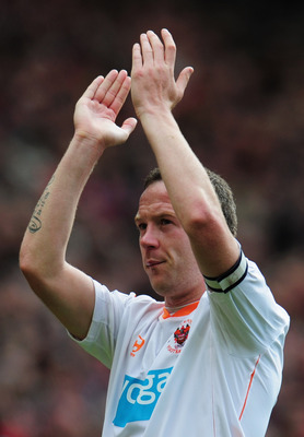 MANCHESTER, ENGLAND - MAY 22:  A dejected Charlie Adam of Blackpool applauds the fans as Blackpool are relegated after the Barclays Premier League match between Manchester United and Blackpool at Old Trafford on May 22, 2011 in Manchester, England.  (Phot