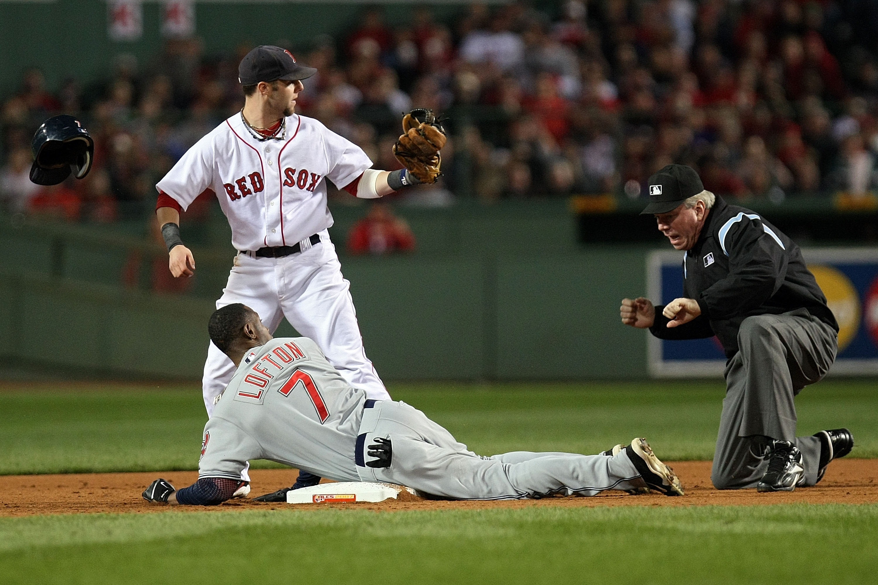 BOSTON - OCTOBER 21:  Kenny Lofton #7 of the Cleveland Indians and Dustin Pedroia #15 of the Boston Red Sox look to second base umpire Brian Gorman as he calls Lofton out at second in the fifth inning of Game Seven of the American League Championship Seri