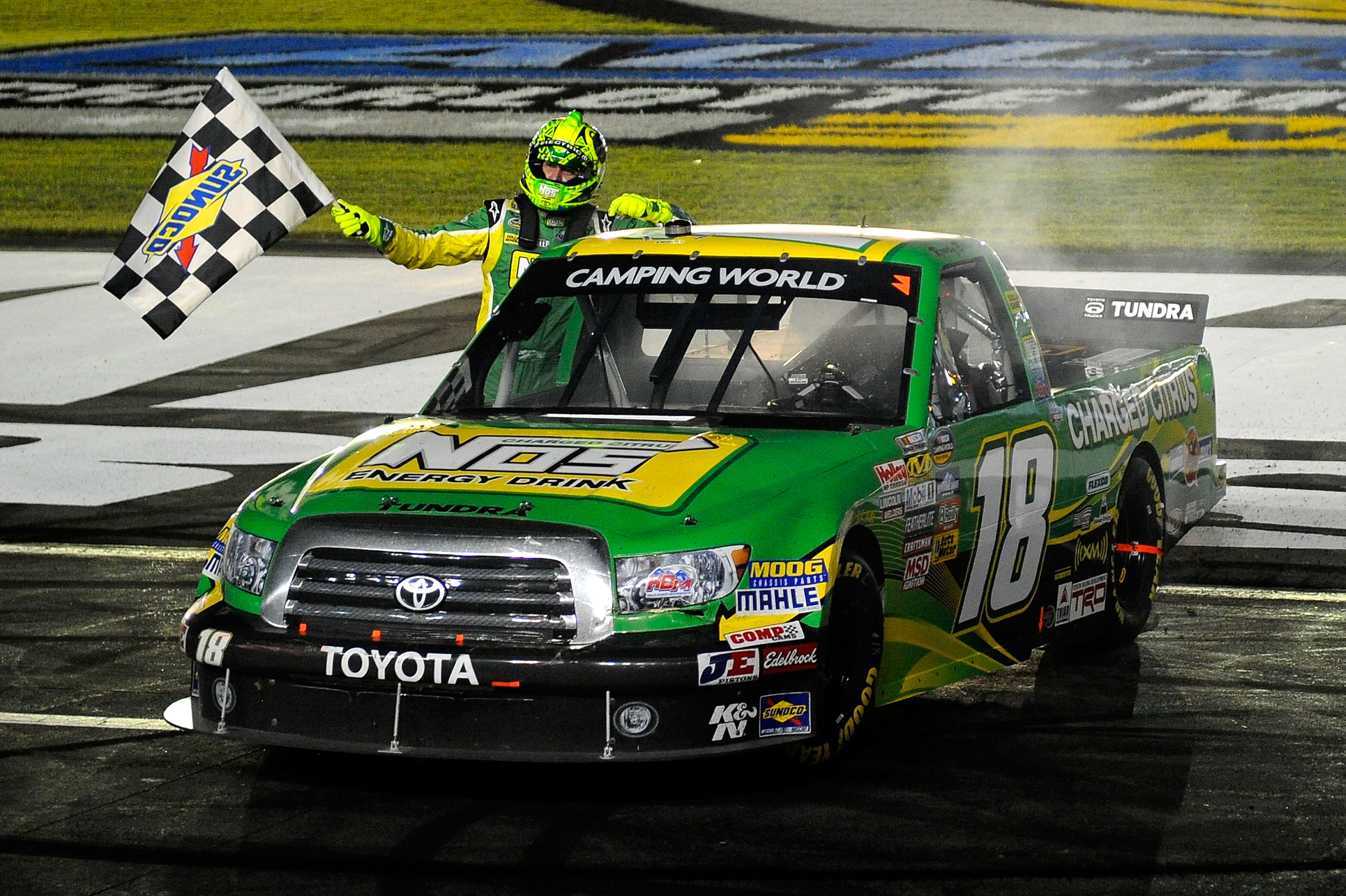 CHARLOTTE, NC - MAY 20:  Kyle Busch, driver of the #18 NOS Energy Drink Toyota, celebrates with the checkered flag after winning the NASCAR Camping World Truck Series North Carolina Education Lottery 200 at Charlotte Motor Speedway on May 20, 2011 in Char