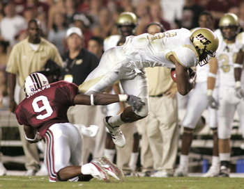 COLUMBIA, SC - SEPTEMBER 1: Jonathan Joseph #9 of the South Carolina Gamecocks trips Brandon Marshall #9 of the University of Central Florida Golden Knights during a game on September 1, 2005 at Williams-Brice Stadium in Columbia, South Carolina. (Photo