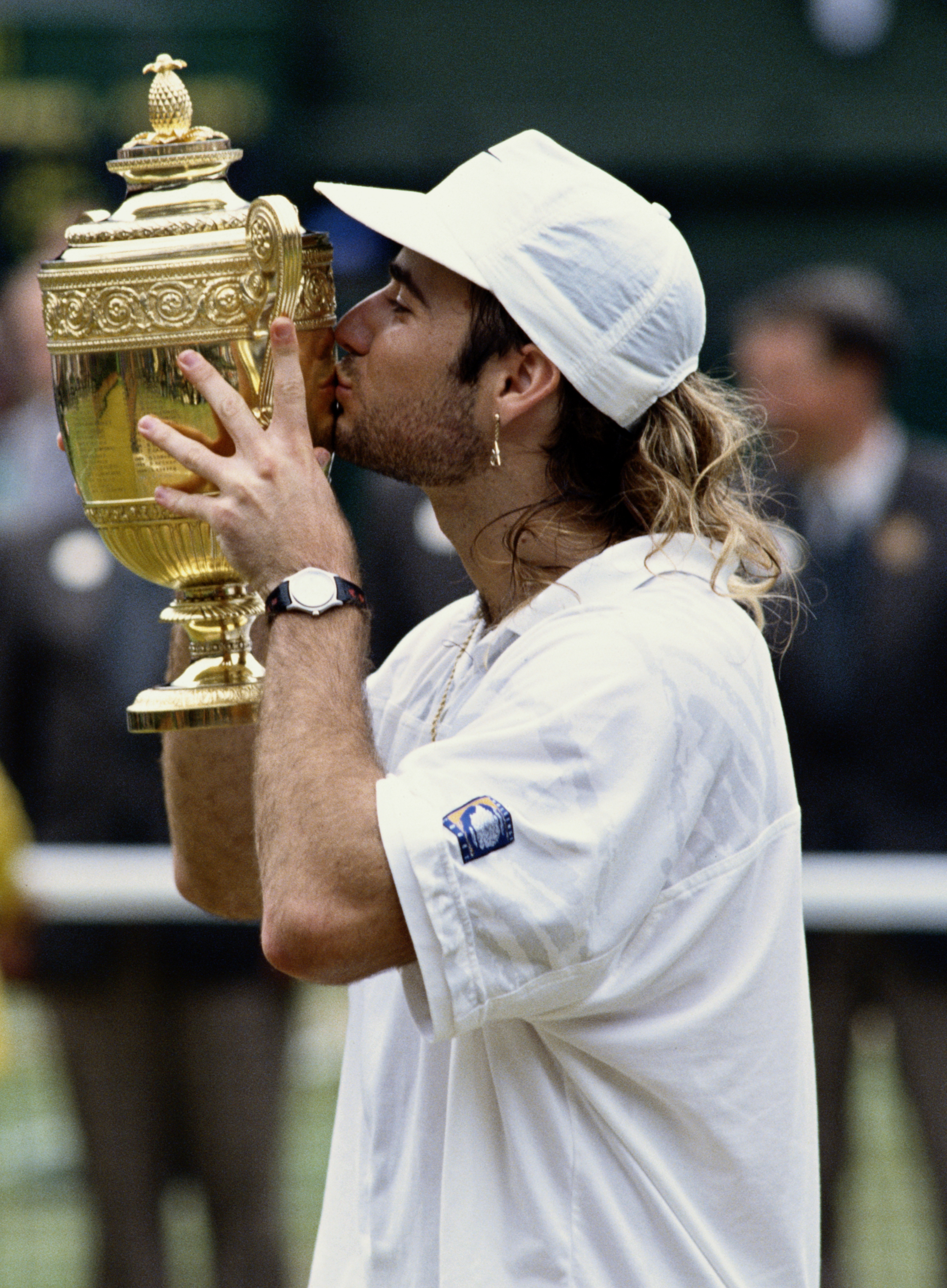 Andre Agassi of the United States kisses the trophy after his  67 (810), 64, 64, 16, 64 victory over Goran Ivanisevicin the Men's Singles Final at the Wimbledon Lawn Tennis Championships on 5th July 1992 at the All England Lawn Tennis and Croquet Cl