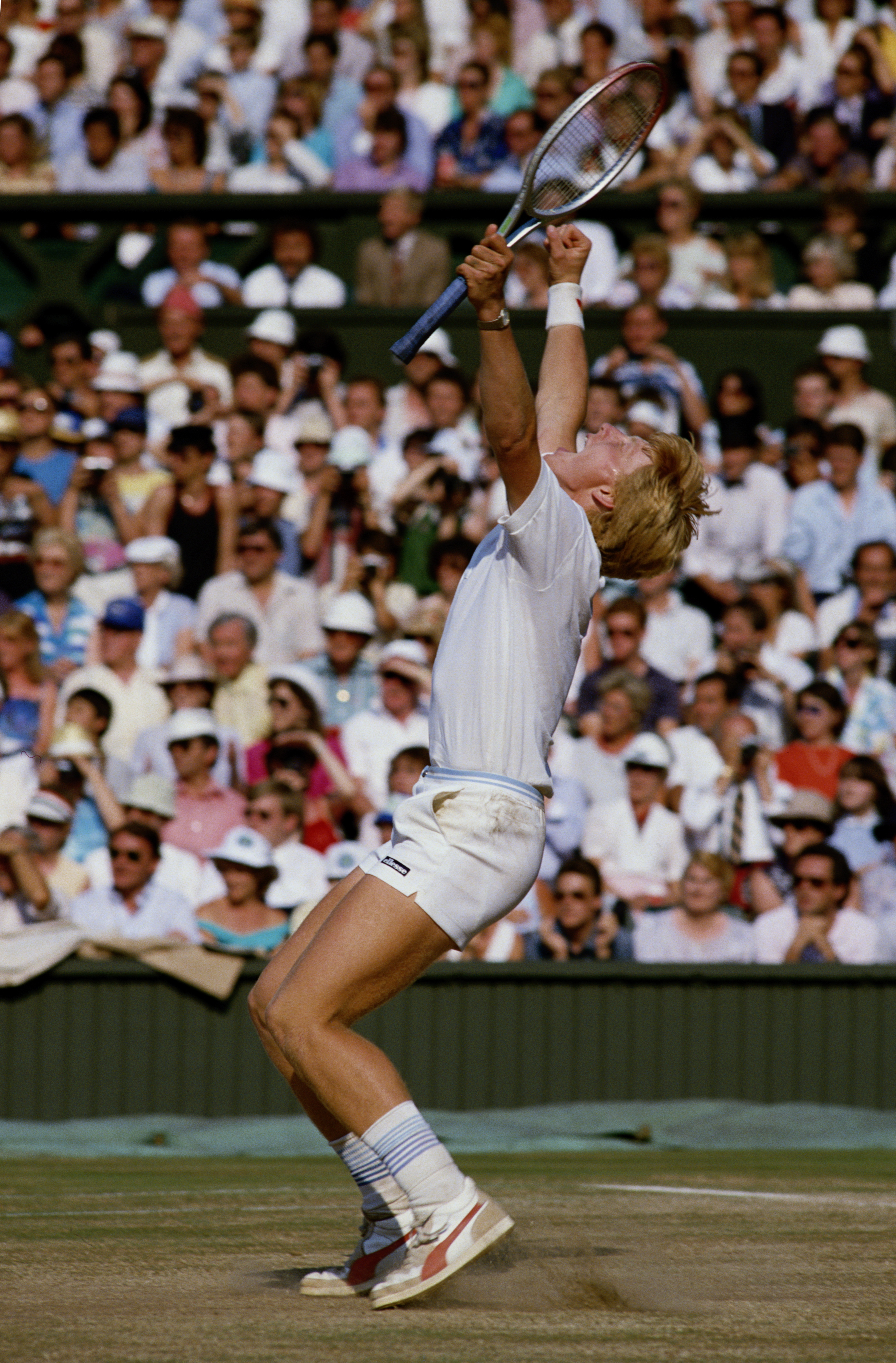 Boris Becker of Germany pumps his arms in the air to celebrate his defeat of Kevin Curren 63, 67 (47), 76 (73), 64 during the Men's Singles final of the Wimbledon Lawn Tennis Championship on 7th July 1985 at the All England Lawn Tennis and Croquet C