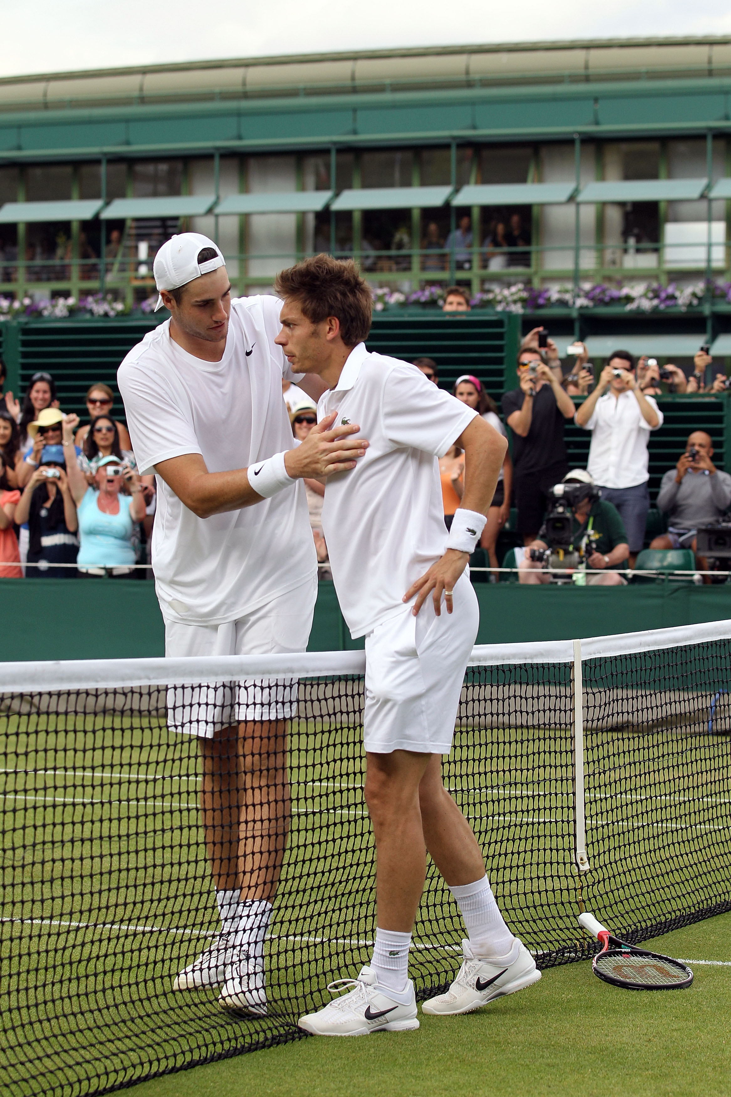 LONDON, ENGLAND - JUNE 24:  Nicolas Mahut of France (R) after losing on the third day of his first round match against John Isner of USA on Day Four of the Wimbledon Lawn Tennis Championships at the All England Lawn Tennis and Croquet Club on June 24, 201