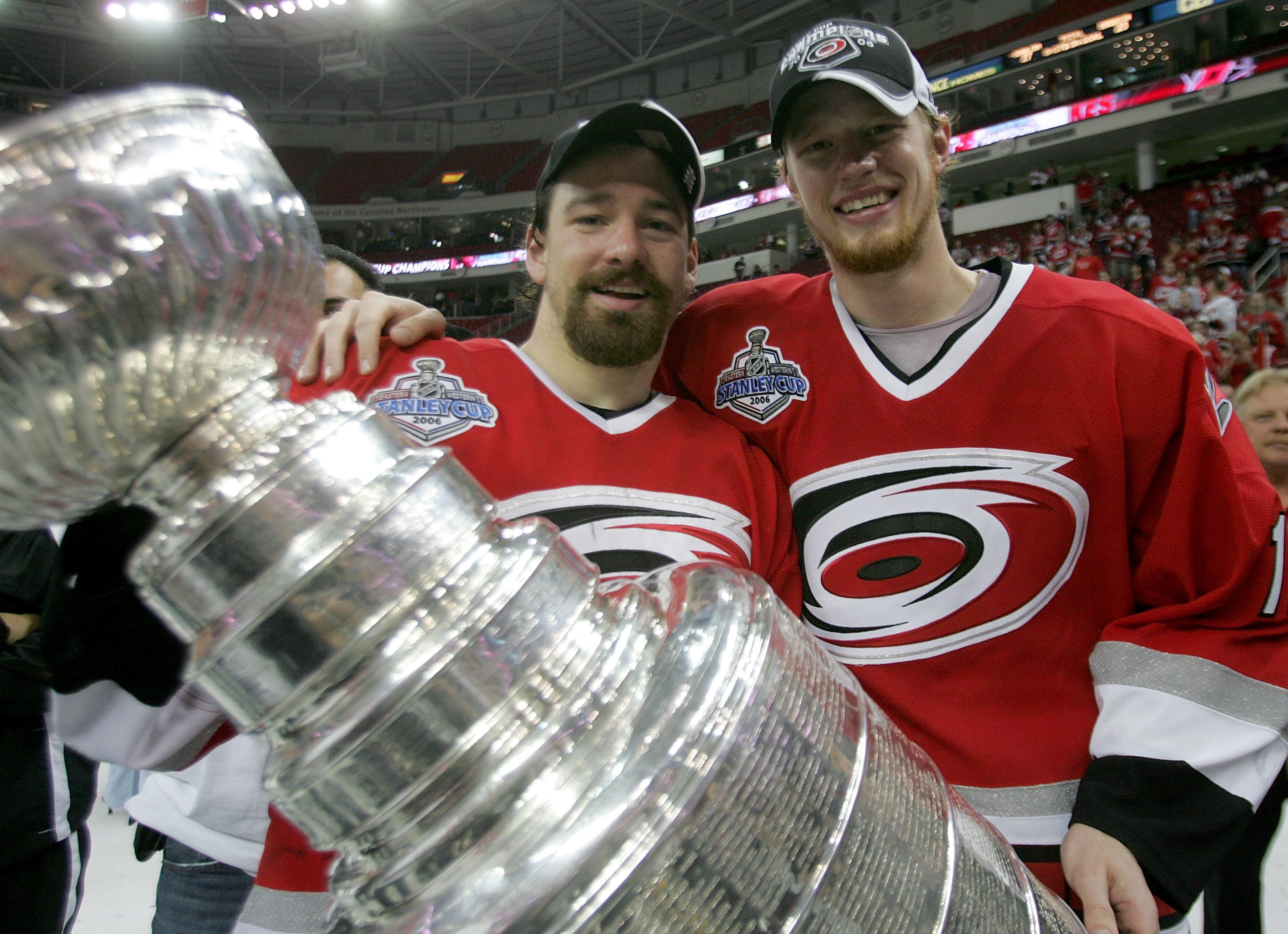 RALEIGH, NC - JUNE 19:  Justin Williams #11 and Eric Staal #12 of the Carolina Hurricanes celebrate with the Stanley Cup after defeating the Edmonton Oilers in game seven of the 2006 NHL Stanley Cup Finals on June 19, 2006 at the RBC Center in Raleigh, No