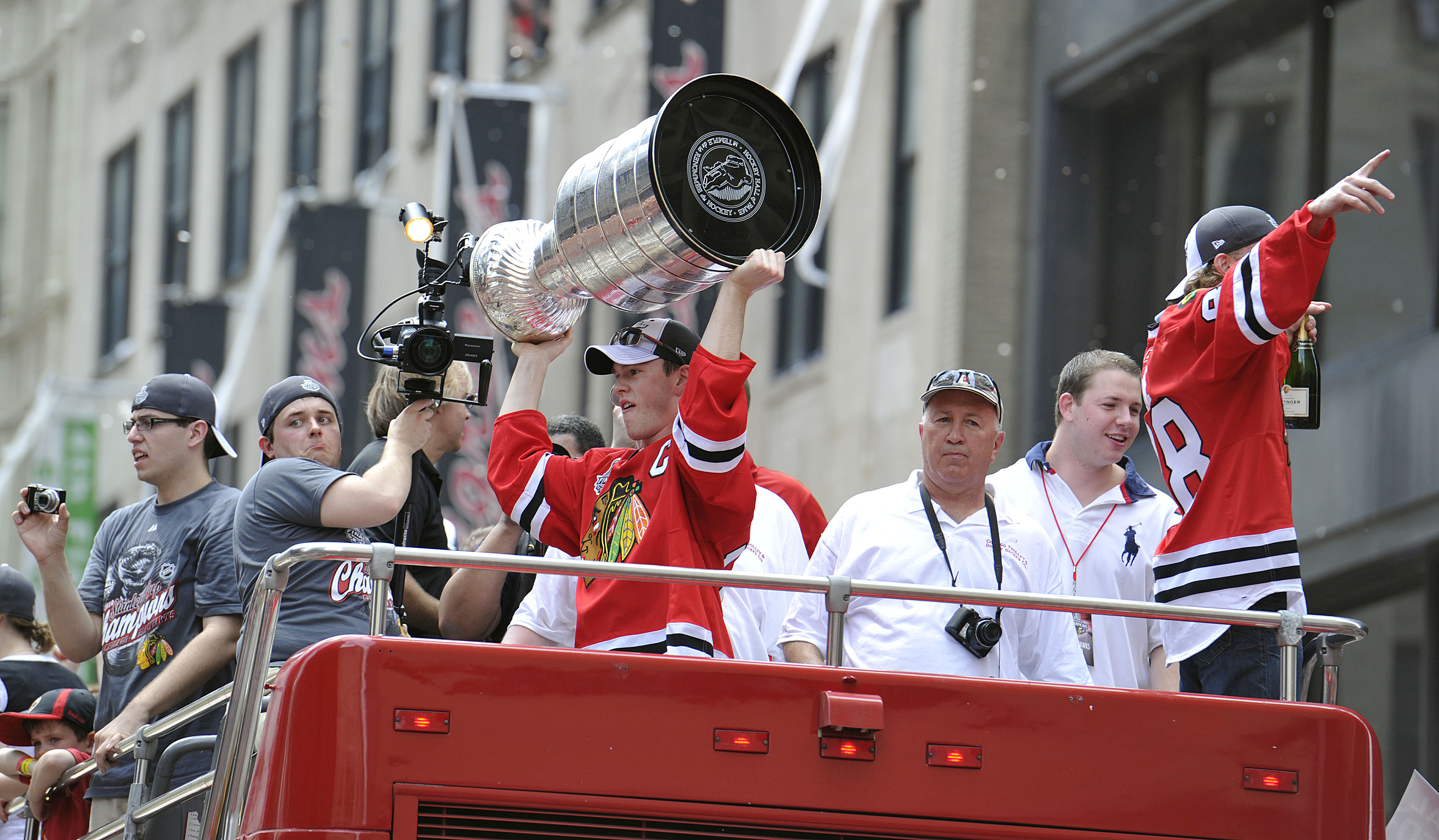 CHICAGO - JUNE 11: Jonathan Toews of the Chicago Blackhawks (L) holds up the Stanley Cup as his teammate, Patrick Kane (R), waves to fans during the Chicago Blackhawks victory parade on June 11, 2010 in Chicago, Illinois. (Photo by Jim Prisching/Getty Ima