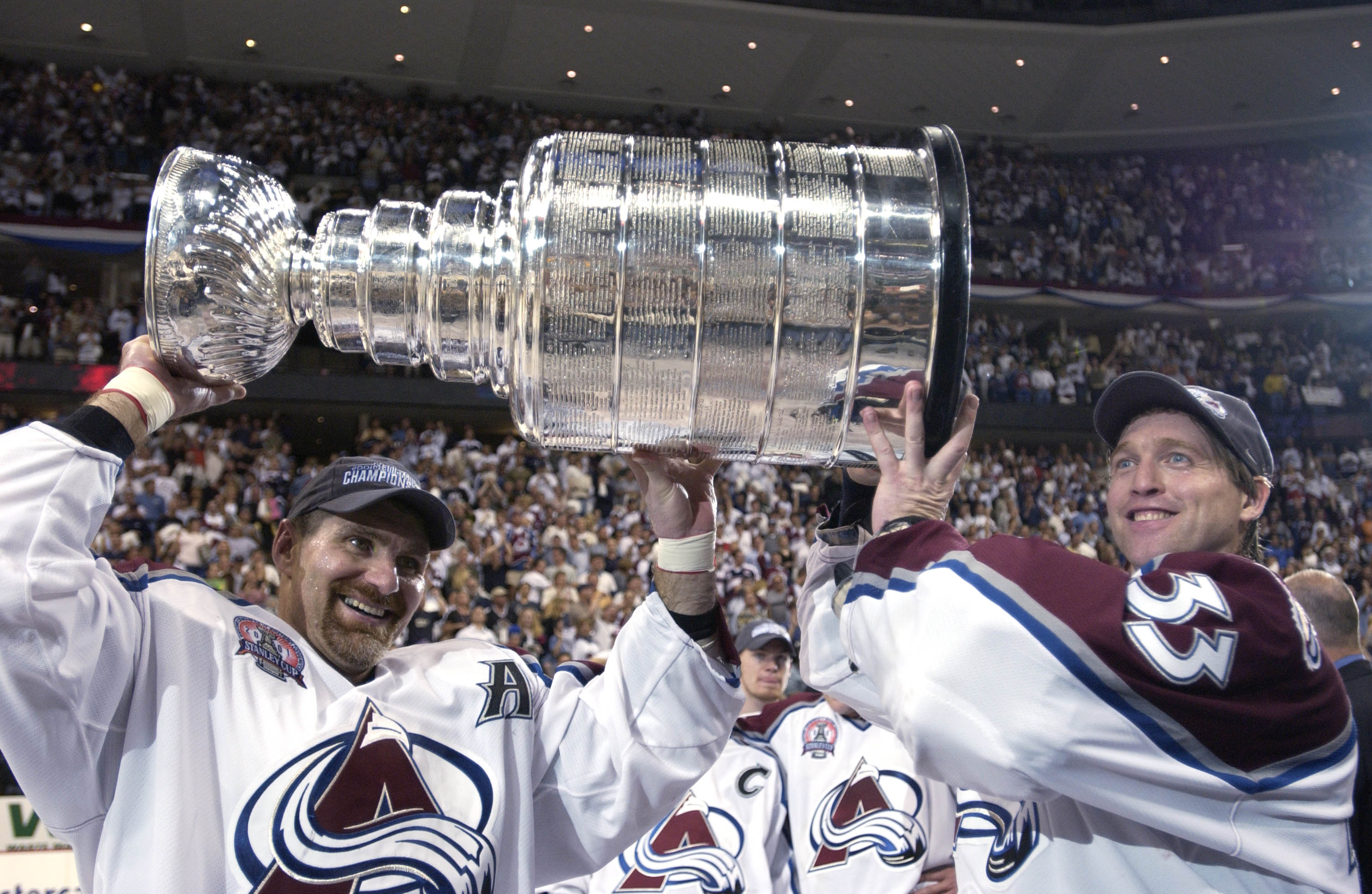9 Jun 2001:  Ray Bourque #77 of the Colorado Avalanche and teammate Patrick Roy #33 raise the Stanley Cup after  they beat the New Jersey Devils 3-1 in game seven of the NHL Stanley Cup Finals at Pepsi Center in Denver, Colorado.  The Avalanche take the s