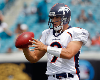 Denver Broncos quarterback Brady Quinn (9) watches counterpart Kyle Orton  throw the ball at football training camp for rookies at the team's facility  in Englewood, Colo., on Thursday, July 29, 2010. For