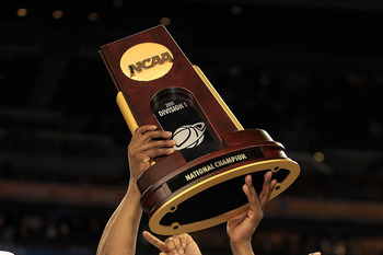 HOUSTON, TX - APRIL 04: Shabazz Napier #13 and Kemba Walker #15 of the Connecticut Huskies celebrate with the trophy after defeating the Butler Bulldogs to win the National Championship Game of the 2011 NCAA Division I Men's Basketball Tournament by a sc