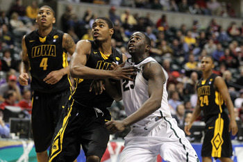 INDIANAPOLIS, IN - MARCH 10: Draymond Green #23 of the Michigan State Spartans fights for rebound position against Melsahn Basabe #1 of the Iowa Hawkeyes during the first round of the 2011 Big Ten Men's Basketball Tournament at Conseco Fieldhouse on Marc