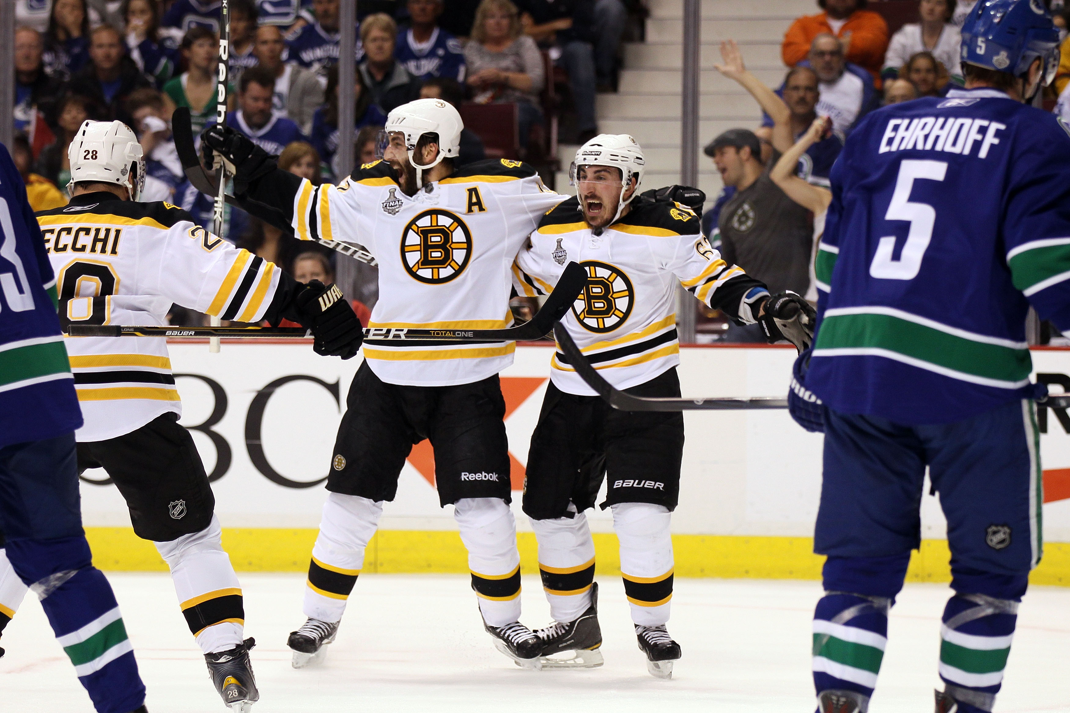 VANCOUVER, BC - JUNE 15:  Patrice Bergeron #37 of the Boston Bruins celebrates with his teammates Mark Recchi #28 and Brad Marchand #63 after scoring a goal in the first period against Roberto Luongo #1 of the Vancouver Canucks during Game Seven of the 20