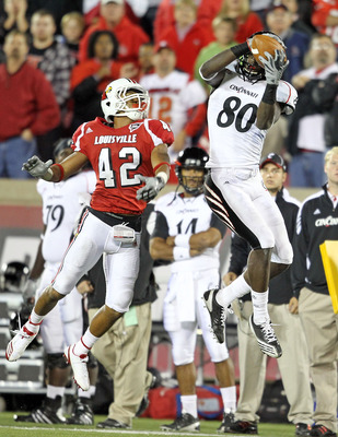 LOUISVILLE, KY - OCTOBER 15: Armon Binns # 80 of the Cincinnati Bearcats catches a touchdown pass during the Big East Conference game while defended by Bobby Burns #42 of the Louisville Cardinals at Papa John's Cardinal Stadium on October 15, 2010 in Lou