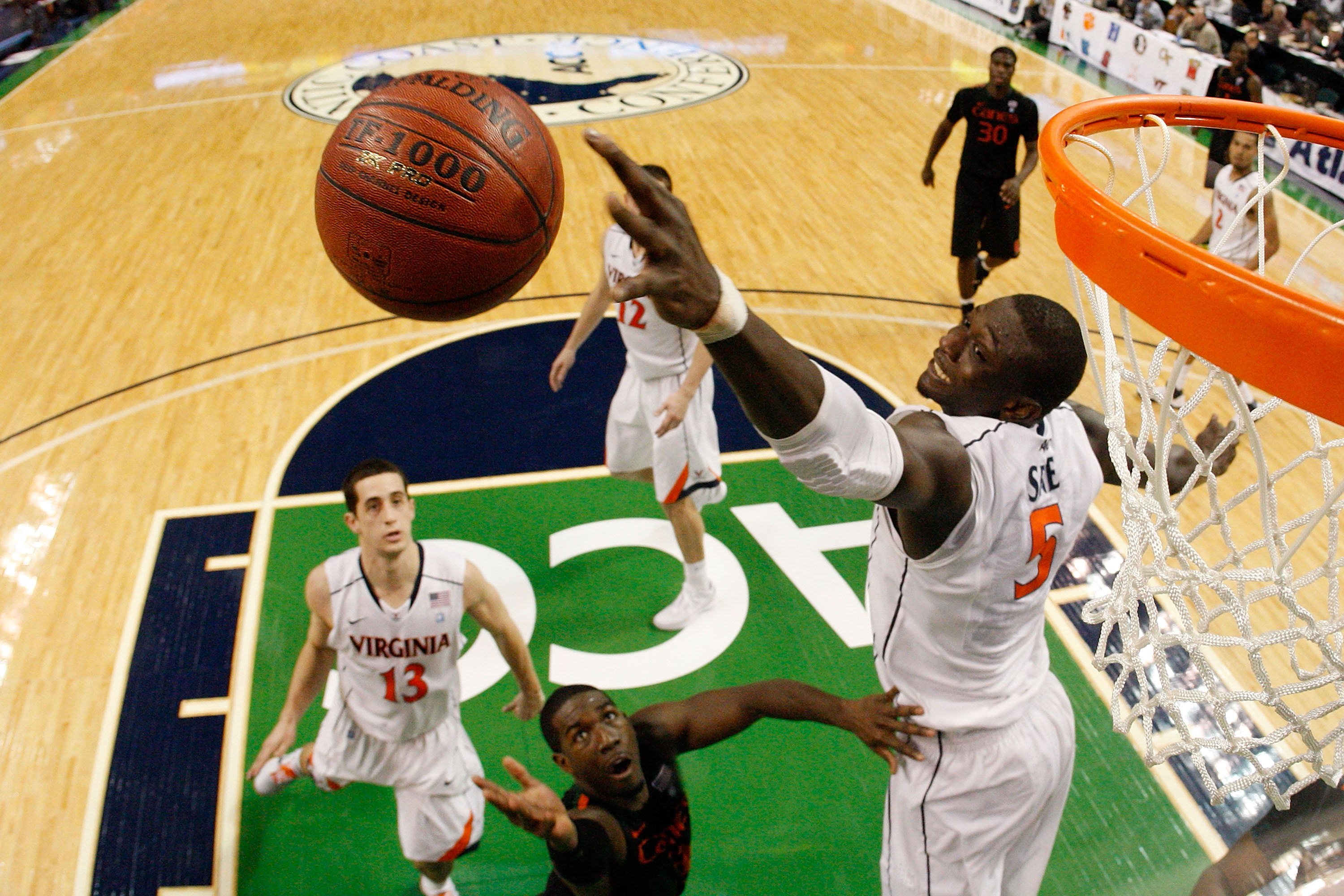 GREENSBORO, NC - MARCH 10:  Assane Sene #5 of the Virginia Cavaliers blocks a shot by during the first round of the 2011 ACC men's basketball tournament at the Greensboro Coliseum on March 10, 2011 in Greensboro, North Carolina.  (Photo by Streeter Lecka/