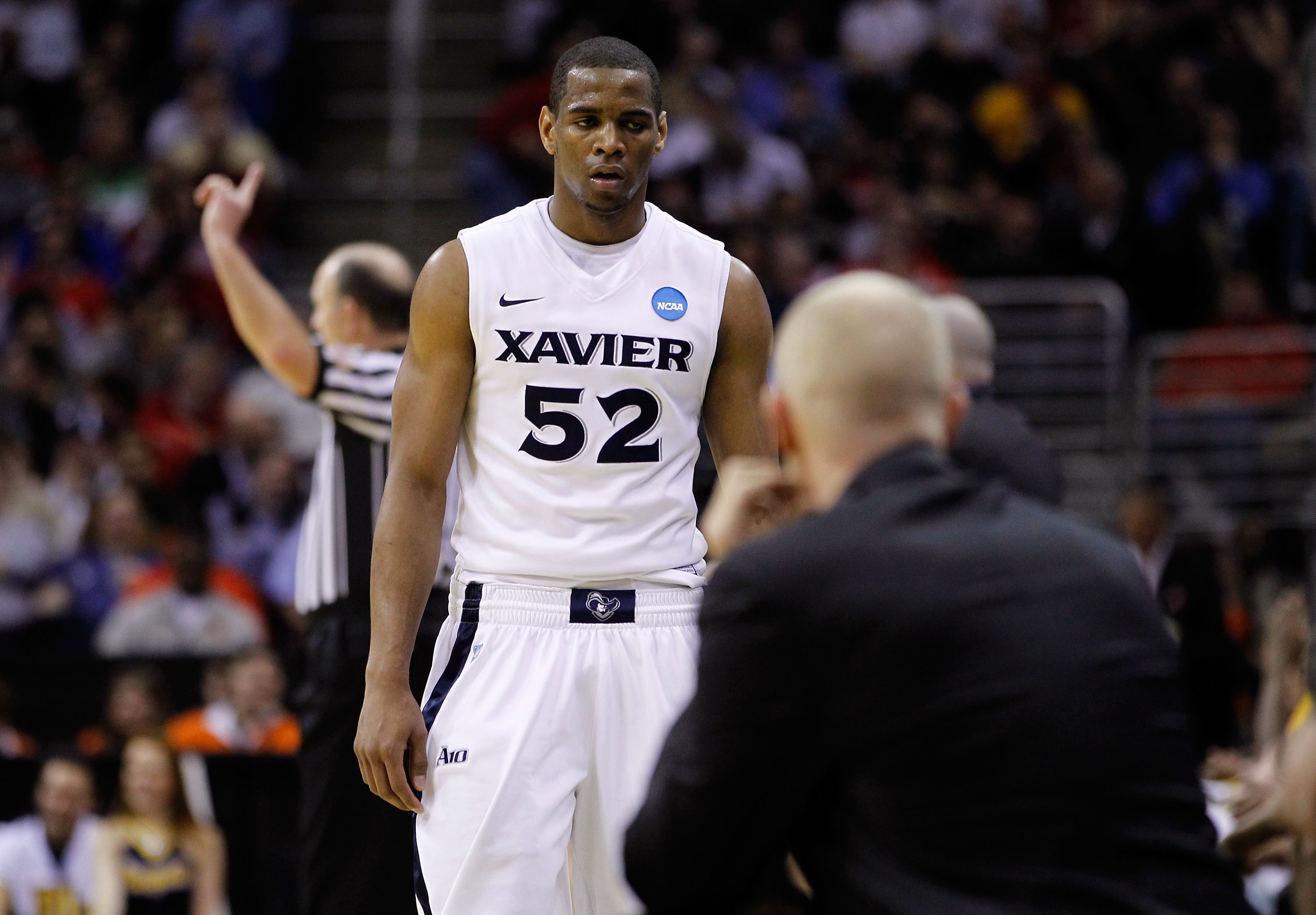 CLEVELAND, OH - MARCH 18: Tu Holloway #52 of the Xavier Musketeers walks to the bench late in the second half against the Marquette Golden Eagles during the second round of the 2011 NCAA men's basketball tournament at Quicken Loans Arena on March 18, 2011
