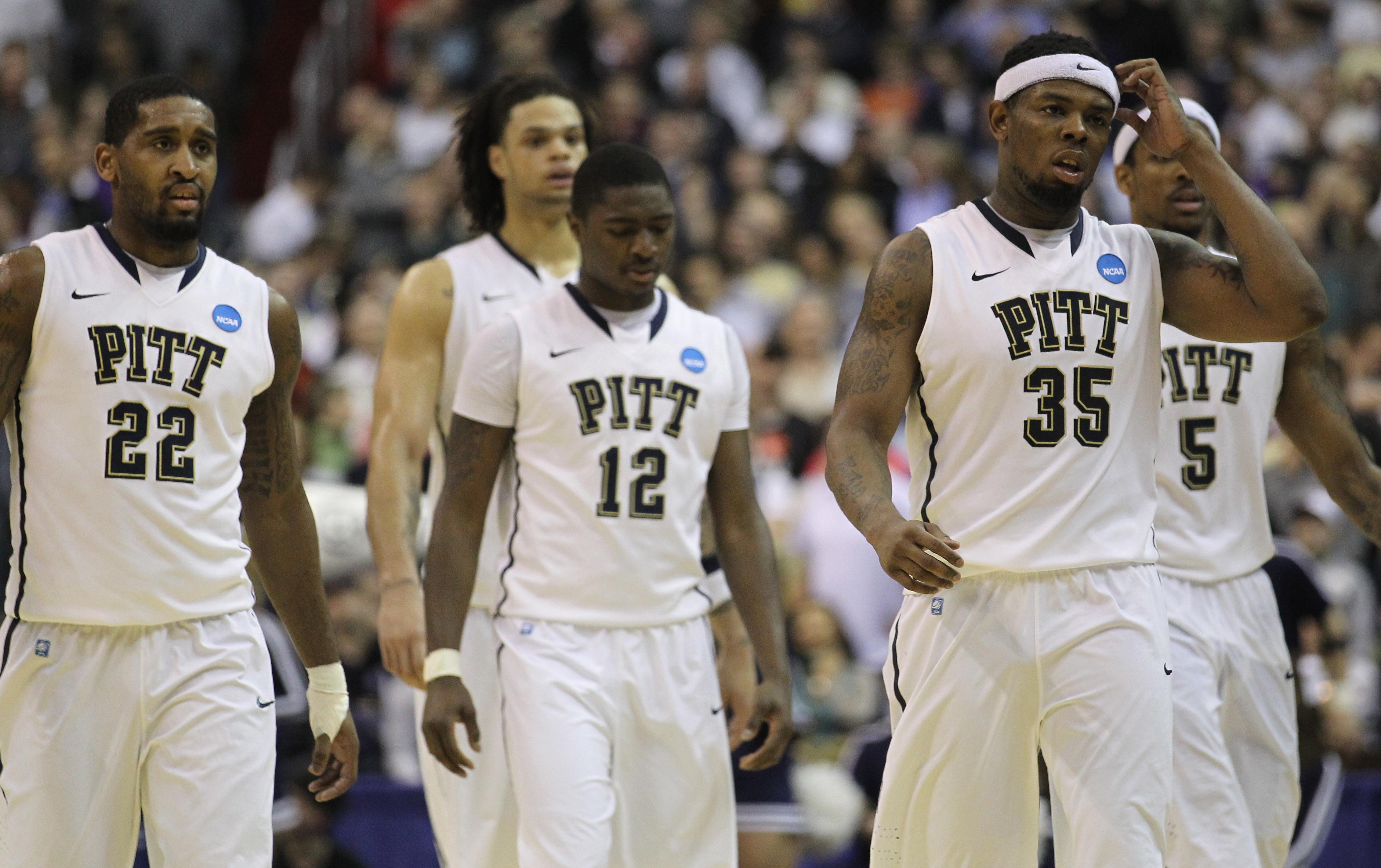 WASHINGTON - MARCH 19:  Members of the Pittsburgh basketball team including Nasir Robinson #35, Ashton Gibbs #12; and Brad Wanamaker#22 walk off the court following their loss against Butler in the third round of the 2011 NCAA men's basketball tournament