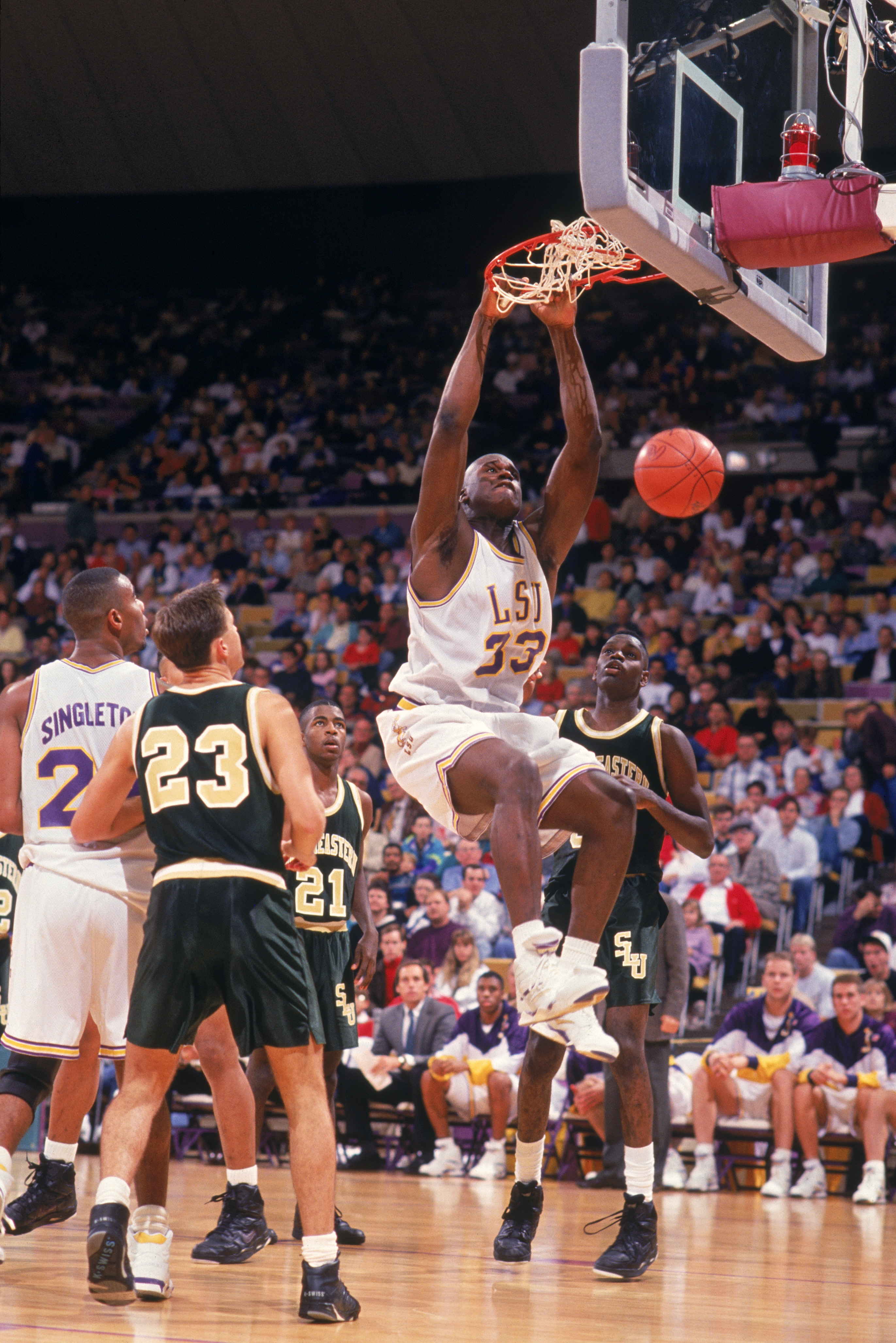1991:  Shaquille O'Neal #33 of the Louisiana State University Tigers makes a slam dunk during an NCAA game against the Southeastern Louisiana University LIons in 1991.  (Phot by Brad Messina/Getty Images)
