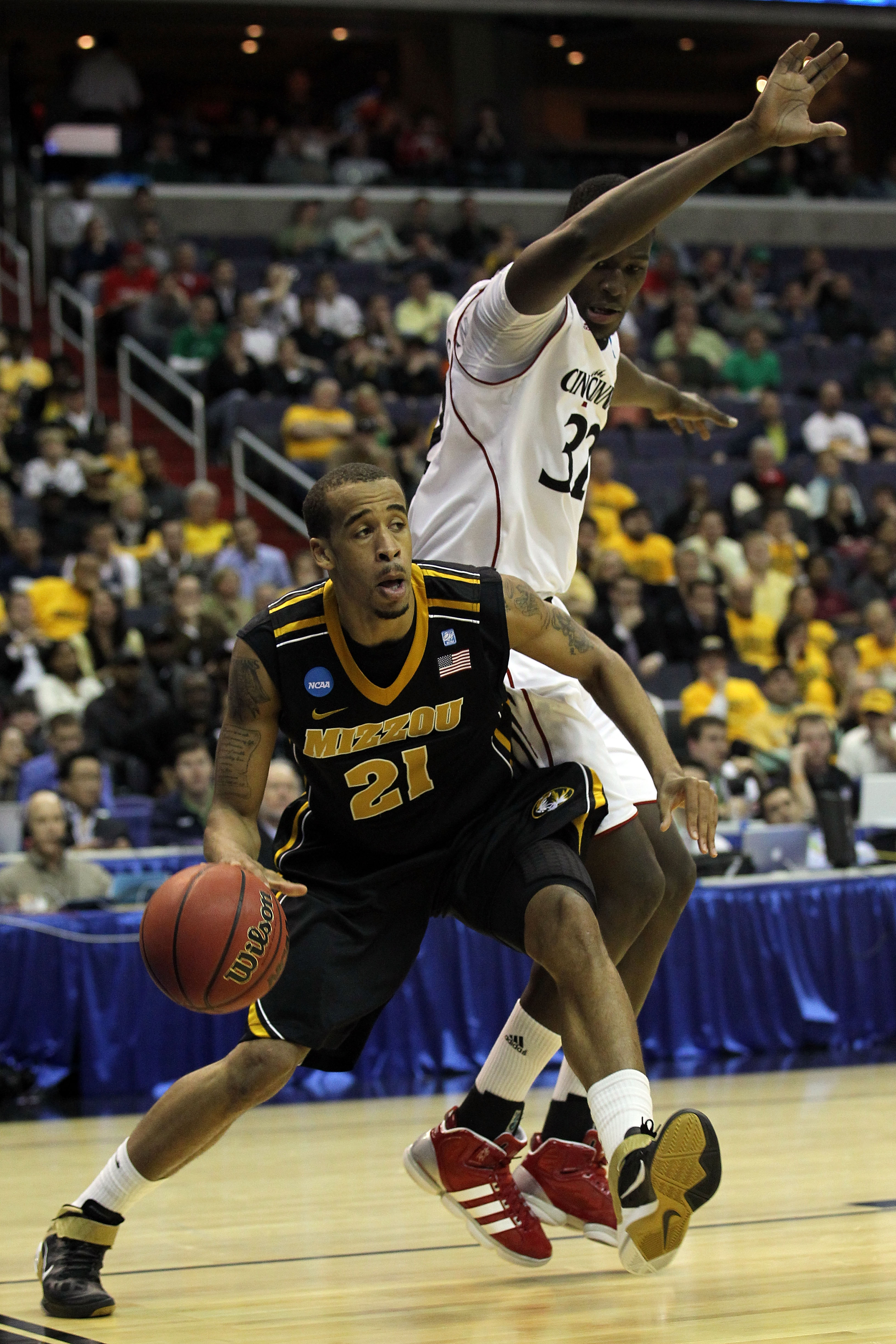WASHINGTON - MARCH 17:  Laurence Bowers #21 of the Missouri Tigers drives the baseline past Ibrahima Thomas #32 of the Cincinnati Bearcats during the second round of the 2011 NCAA men's basketball tournament at the Verizon Center on March 17, 2011 in Wash