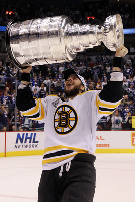 VANCOUVER, BC - JUNE 15:  David Krejci #46 of the Boston Bruins celebrates with the Stanley Cup after defeating the Vancouver Canucks in Game Seven of the 2011 NHL Stanley Cup Final at Rogers Arena on June 15, 2011 in Vancouver, British Columbia, Canada.
