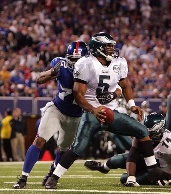 New York Giants Osi Umenyiora (72) sacks Philadelphia Eagles quarterback  Donovan McNabb on the Philadelphia 30-yard line during first quarter play  at Philadelphia's Lincoln Field December 9, 2007.Helping him is teammate  Giants