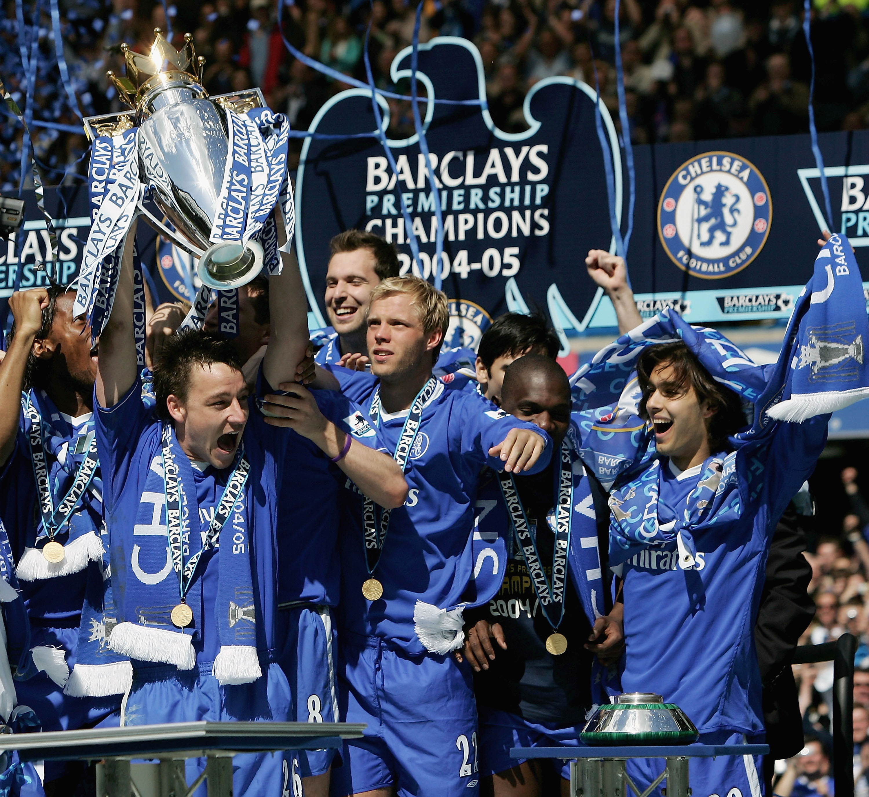 LONDON - MAY 7:  John Terry lifts the trophy up as his Chelsea team mates celebrate receiving the Barclays Premiership Trophy at Stamford Bridge on May 7, 2005 in London, England.  (Photo by Ben Radford/Getty Images)