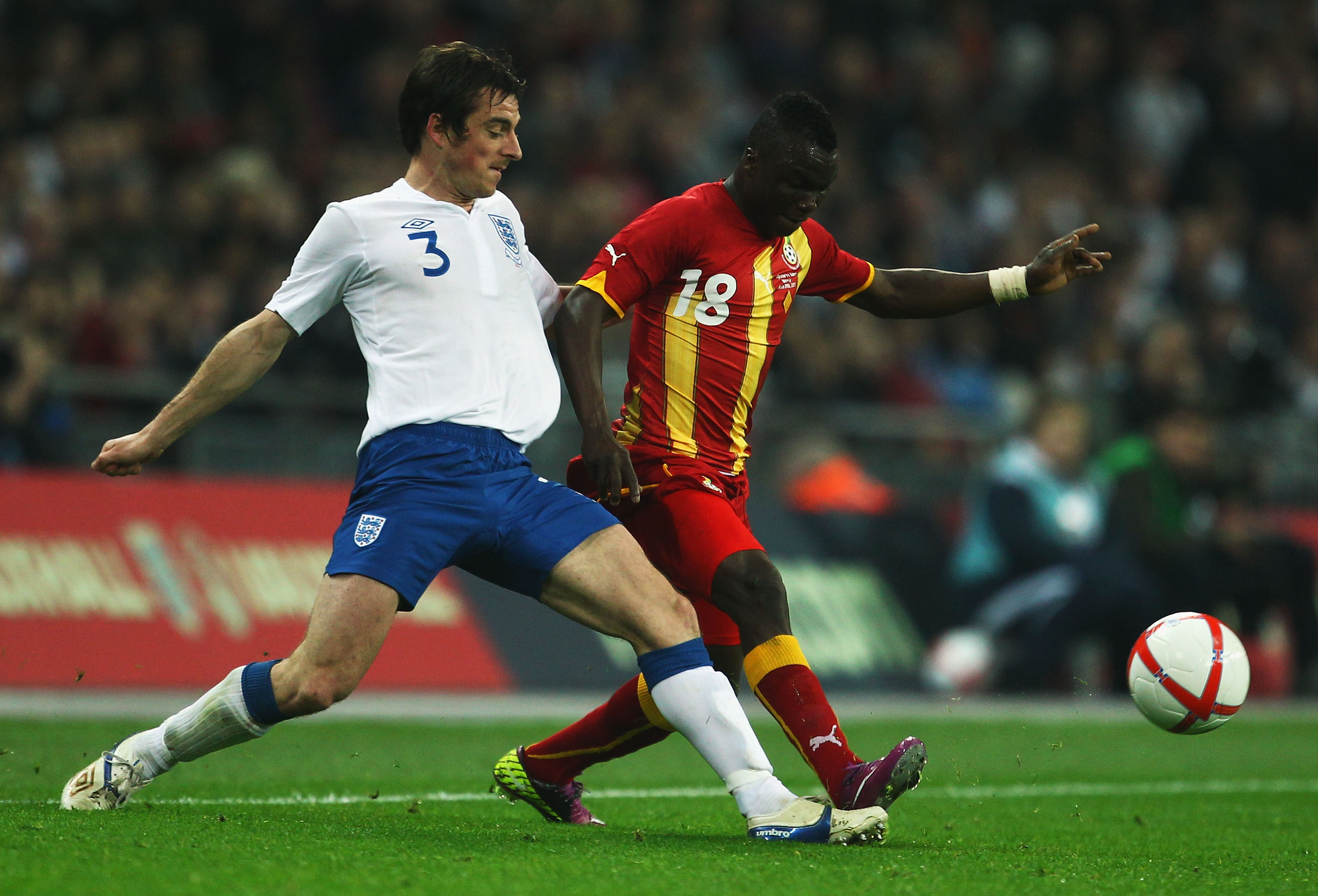 LONDON, ENGLAND - MARCH 29:  Leighton Baines of England (L) clashes with Dominic Adiyiah of Ghana during the international friendly match between England and Ghana at Wembley Stadium on March 29, 2011 in London, England.  (Photo by Julian Finney/Getty Ima