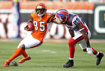 CINCINNATI - NOVEMBER 21:  Chad Ochocinco #85 of the Cincinnati Bengals runs with the ball while defended by Drayton Florence #29 of the Buffalo Bills during the NFL game  at Paul Brown Stadium on November 21, 2010 in Cincinnati, Ohio.  The Bills won 49-3