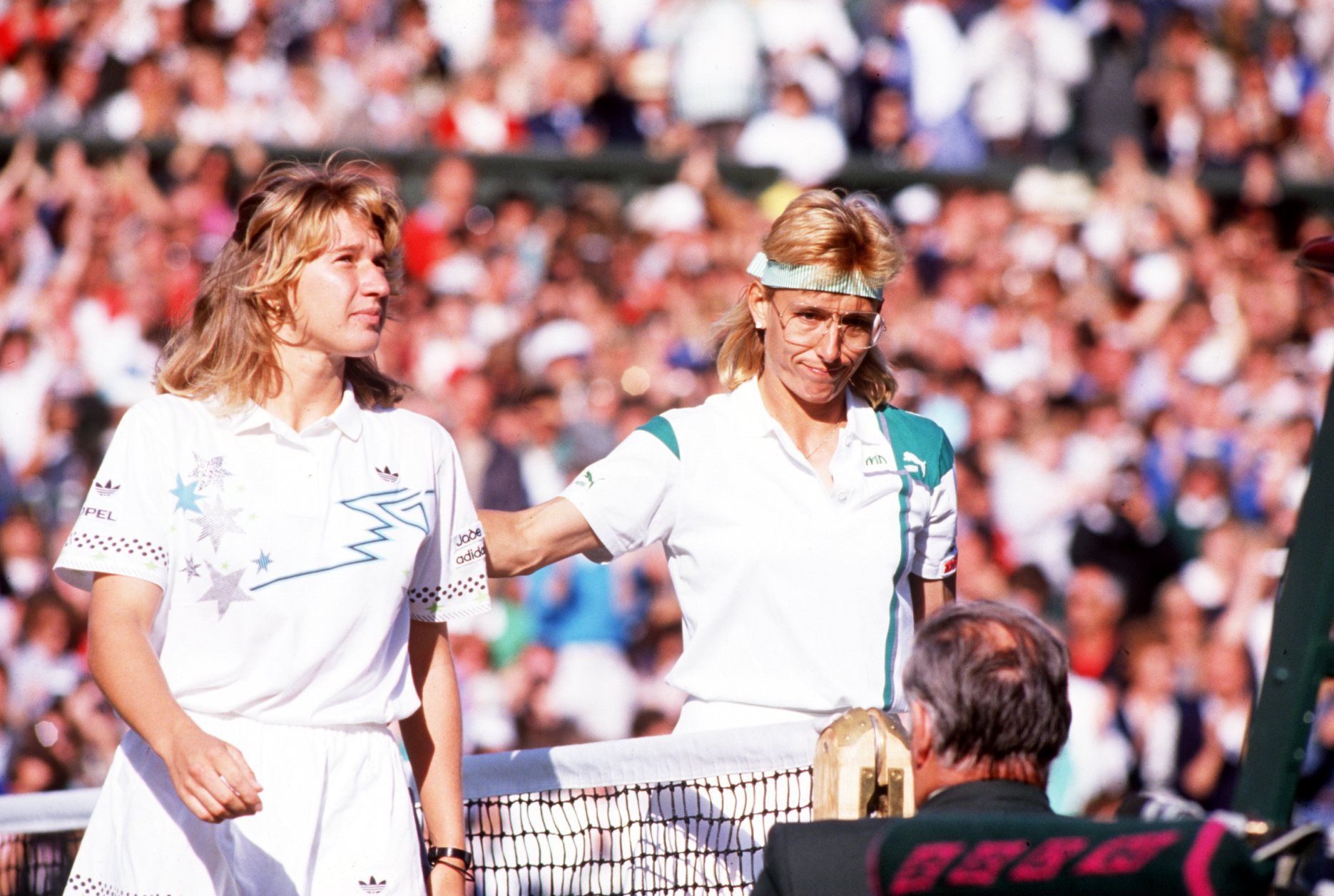 JUL 1988:  STEFFI GRAF OF GERMANY IS PATTED ON THE BACK BY MARTINA NAVRATILOVA OF THE UNITES STATES AFTER THEIR MATCH ON CENTRE COURT DURING THE WIMBLEDON TENNIS CHAMPIONSHIPS. Mandatory Credit: Bob Martin/ALLSPORT