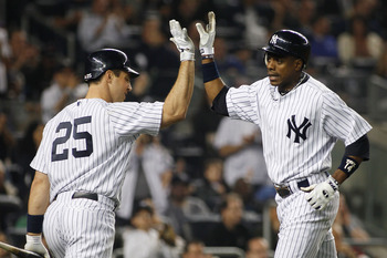 NEW YORK - MAY 21: Curtis Granderson #14 of the New York Yankees is congratulated by teammate Mark Teixeira #25 after hitting a two-run homerun in the bottom of the sixth inning against the New York Mets on May 21, 2011 at Yankee Stadium in the Bronx boro